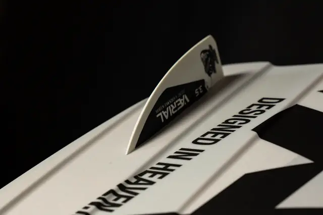 White VÆRIAL board tip with a 3.5 G10 fin and the print “Designed in heaven. Made in Europe.”
